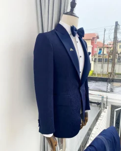 A midnight blue peak lapel floral jacquard tuxedo suit