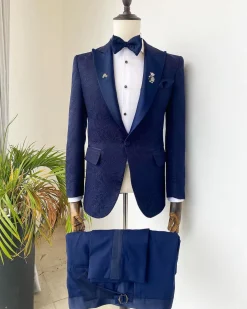 A midnight blue peak lapel floral jacquard tuxedo suit