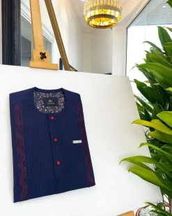 A midnight blue, red pencil stripe, clear view lipstick, red buttons, and horizontal embroidery details African traditional senator Kaftan native