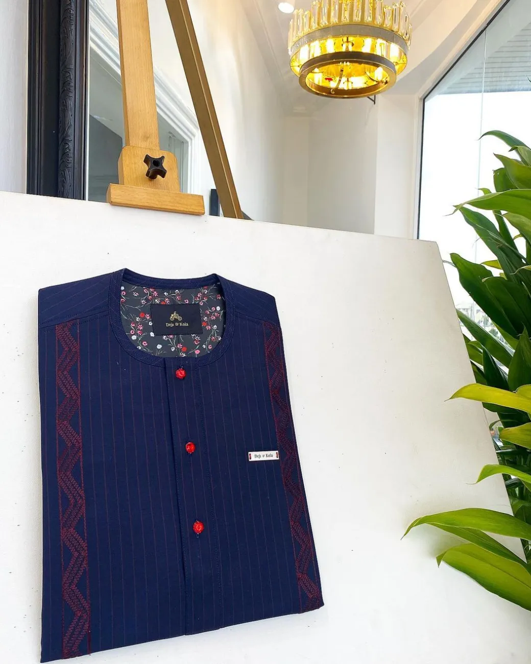 A midnight blue, red pencil stripe, clear view lipstick, red buttons, and horizontal embroidery details African traditional senator Kaftan native