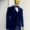 A midnight blue shawl lapel soaked velvet tuxedo suit