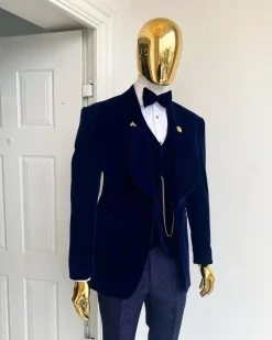 A midnight blue shawl lapel soaked velvet tuxedo suit
