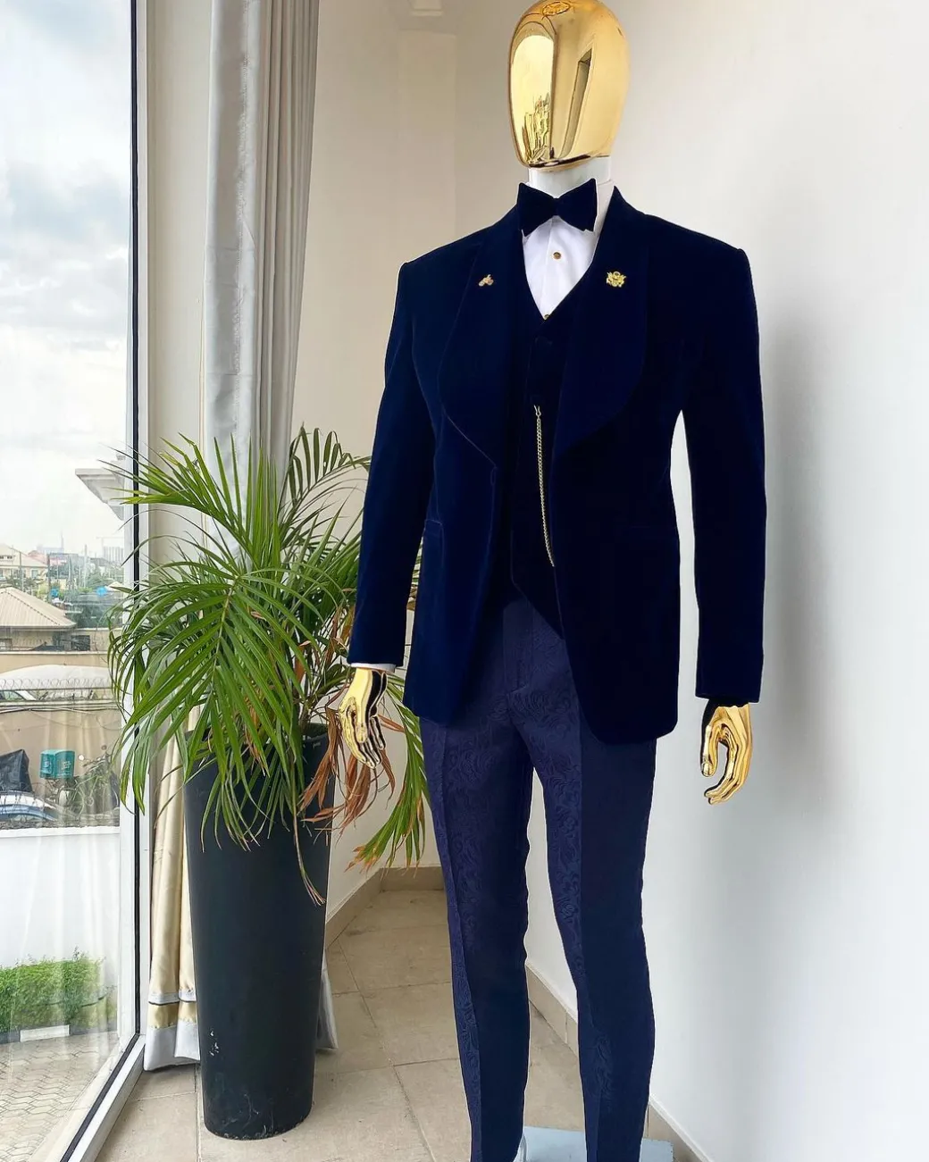 A midnight blue shawl lapel soaked velvet tuxedo suit