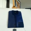 A midnight blue with a paisley flowery left section, complementary front flap, and patch pocket African Kaftan