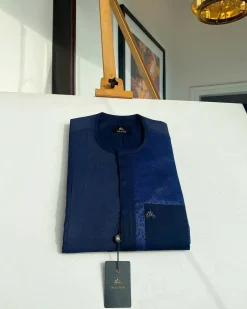 A midnight blue with a paisley flowery left section, complementary front flap, and patch pocket African Kaftan