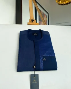 A midnight blue with a paisley flowery left section, complementary front flap, and patch pocket African Kaftan
