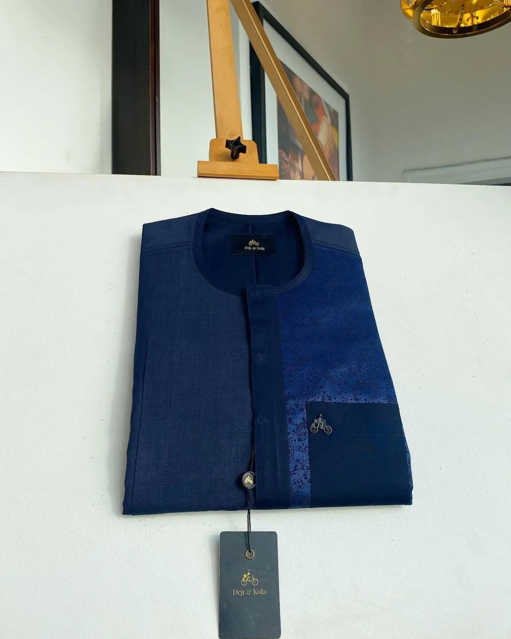 A midnight blue with a paisley flowery left section, complementary front flap, and patch pocket African Kaftan