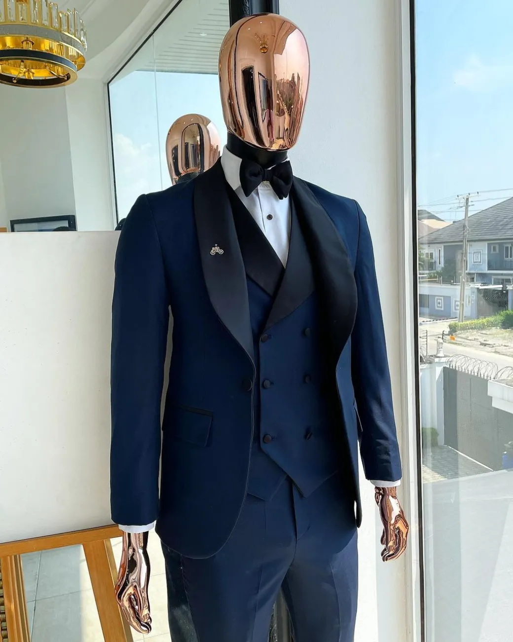 A Midnight Blue with black shawl lapel tuxedo suit