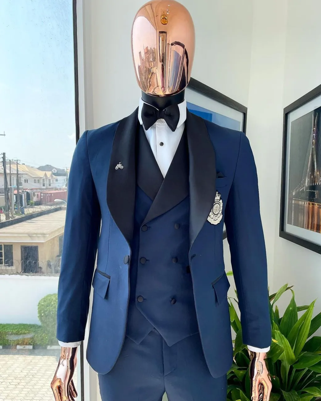A Midnight Blue with black shawl lapel tuxedo suit