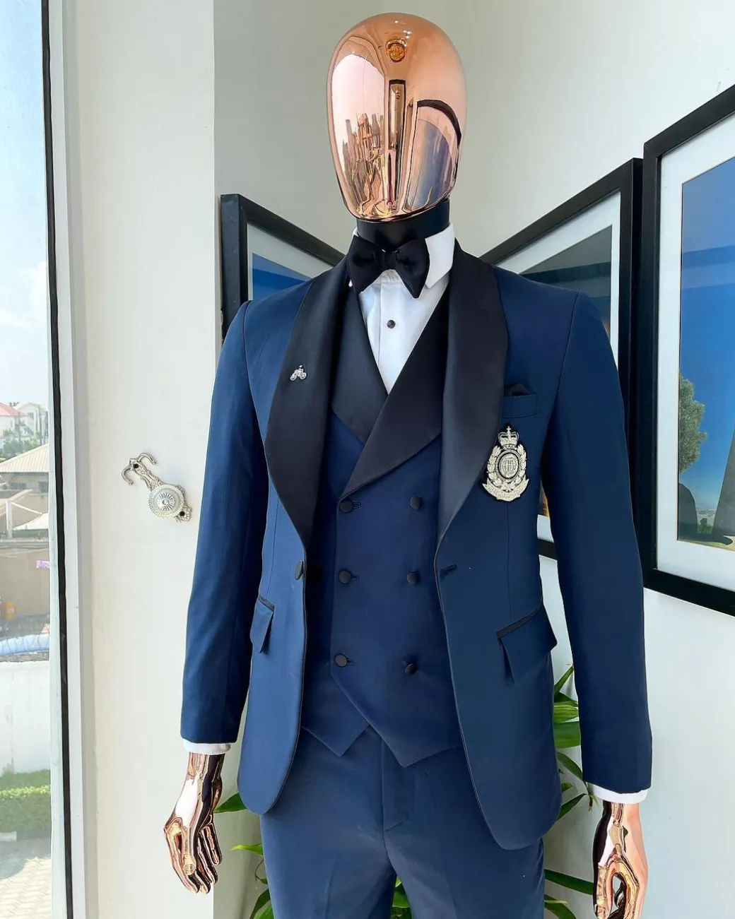 A Midnight Blue with black shawl lapel tuxedo suit