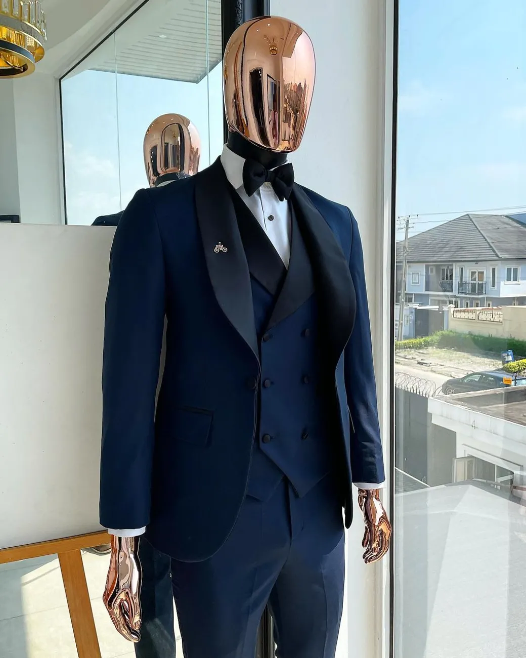 A Midnight Blue with black shawl lapel tuxedo suit