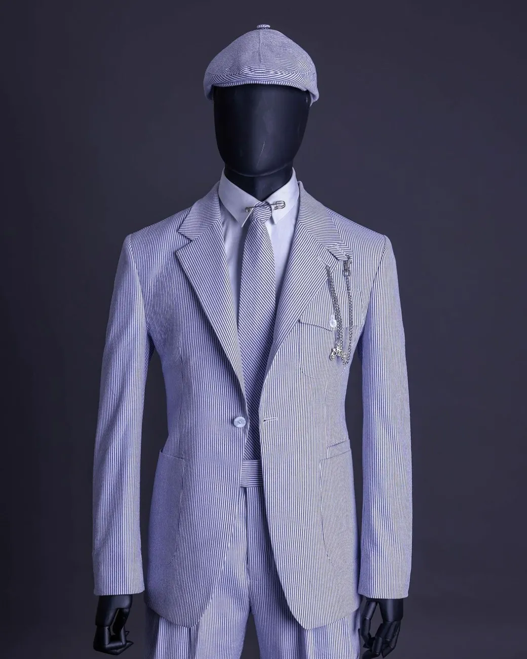 A monochrome seersucker (rail road stripe) notch lapel suit