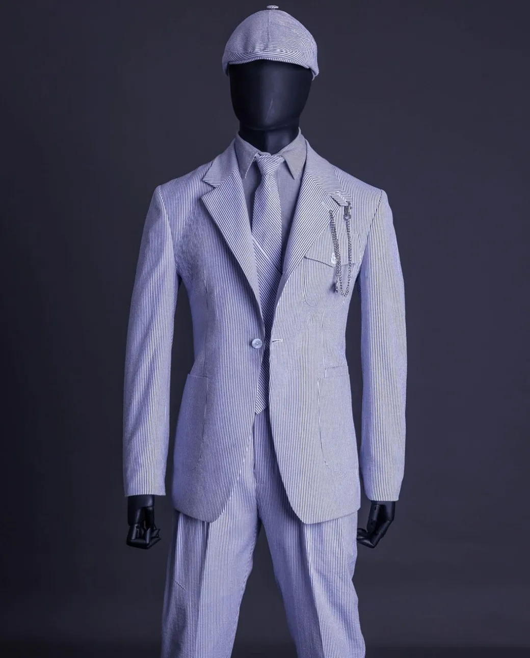 A monochrome seersucker (rail road stripe) notch lapel suit