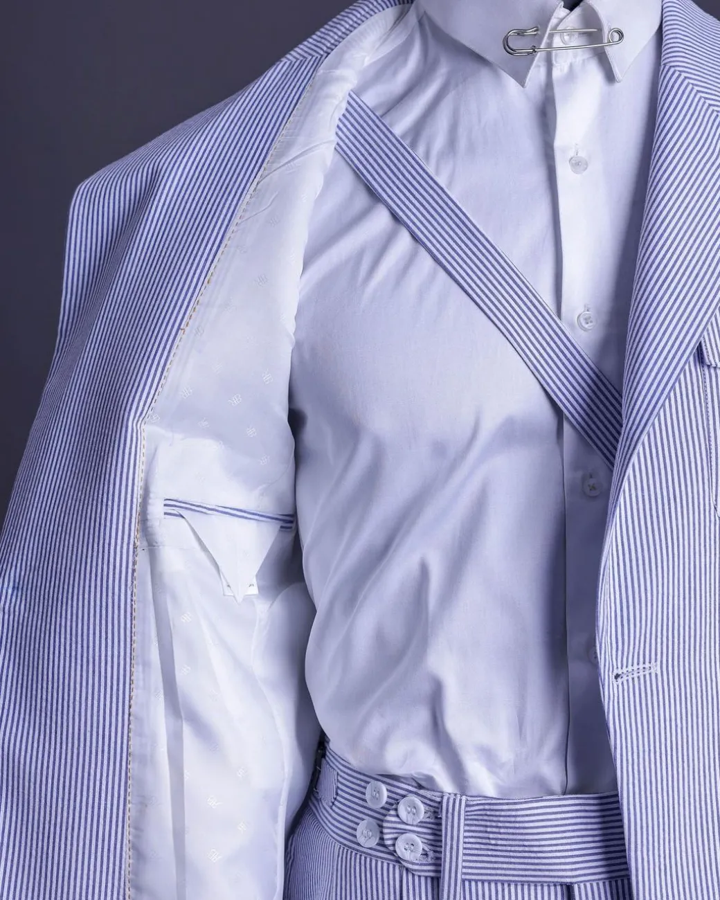 A monochrome seersucker (rail road stripe) notch lapel suit