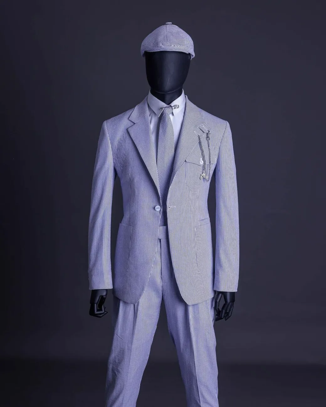A monochrome seersucker (rail road stripe) notch lapel suit