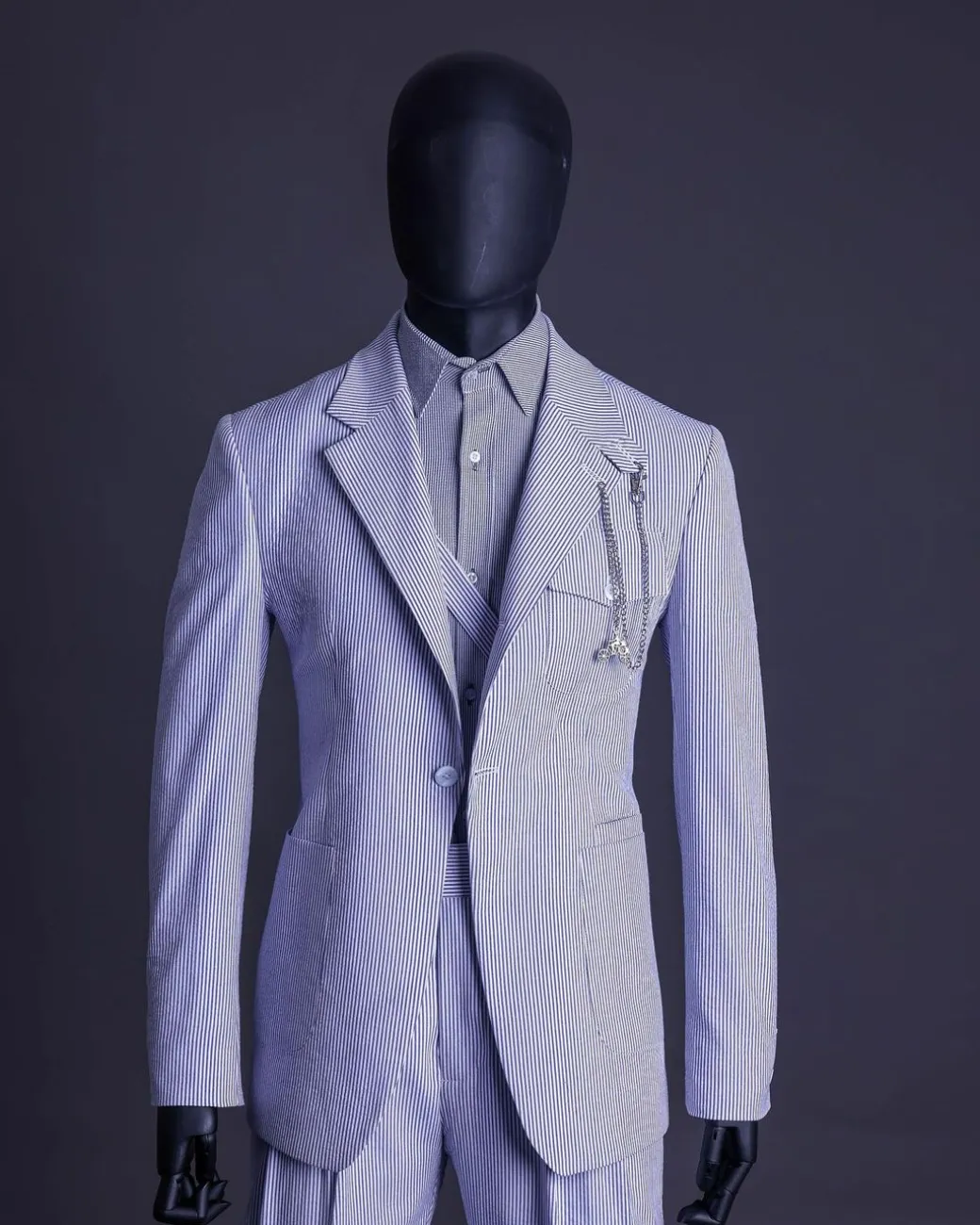 A monochrome seersucker (rail road stripe) notch lapel suit