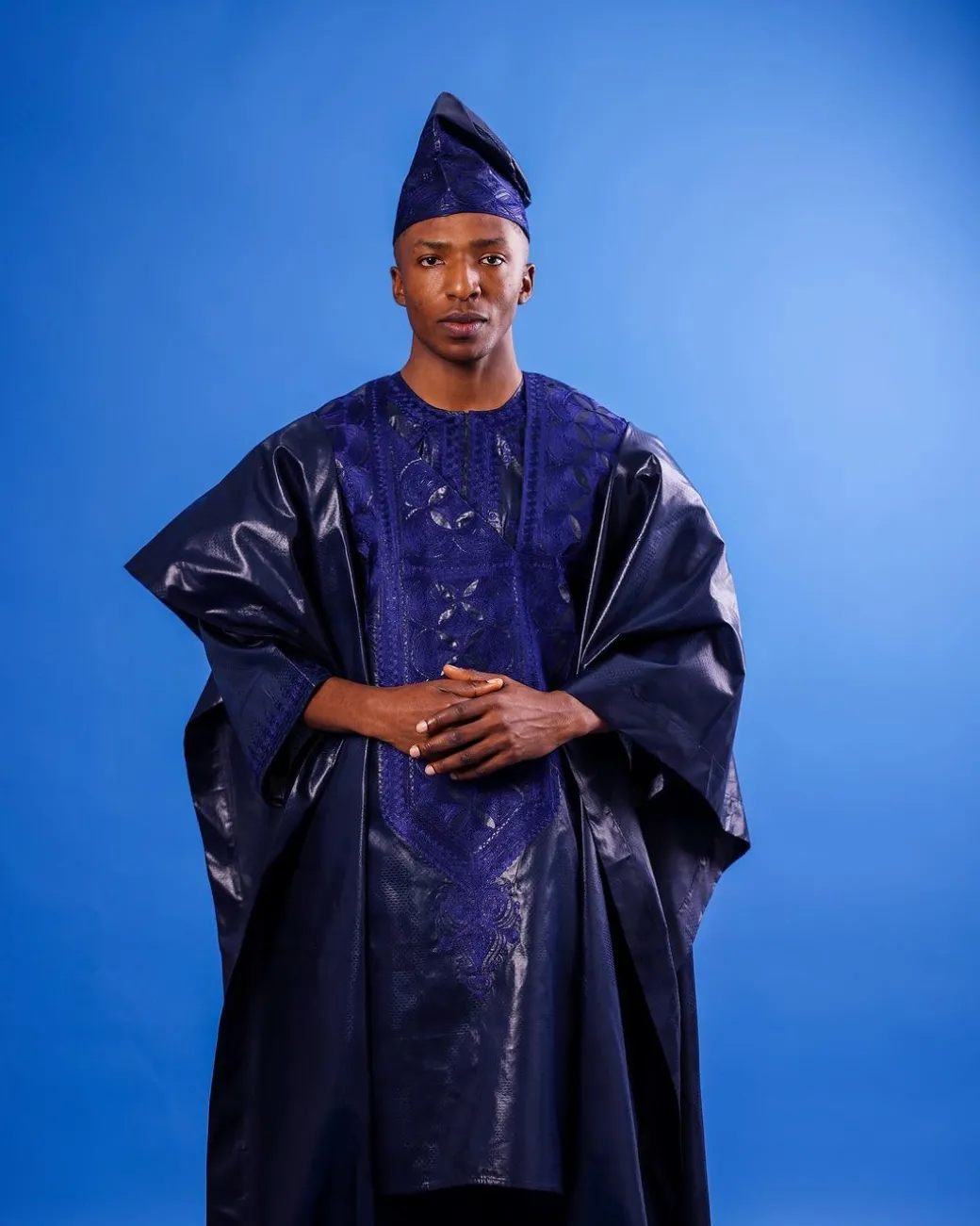A Navy blue “Arewa” embroidery front cut towards back, traditional Agbada, 3/4 sleeve kaftan, and Sokoto
