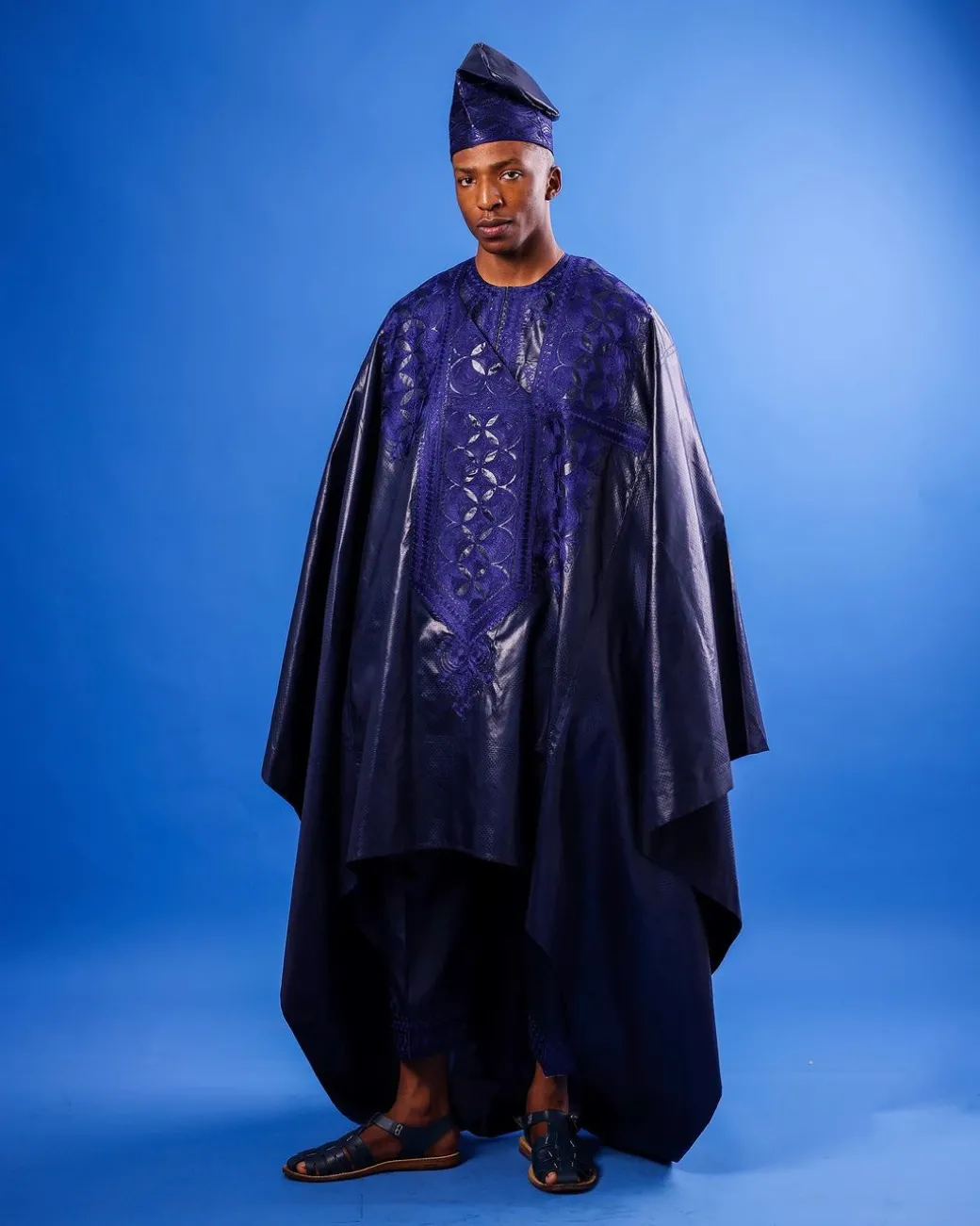 A Navy blue “Arewa” embroidery front cut towards back, traditional Agbada, 3/4 sleeve kaftan, and Sokoto