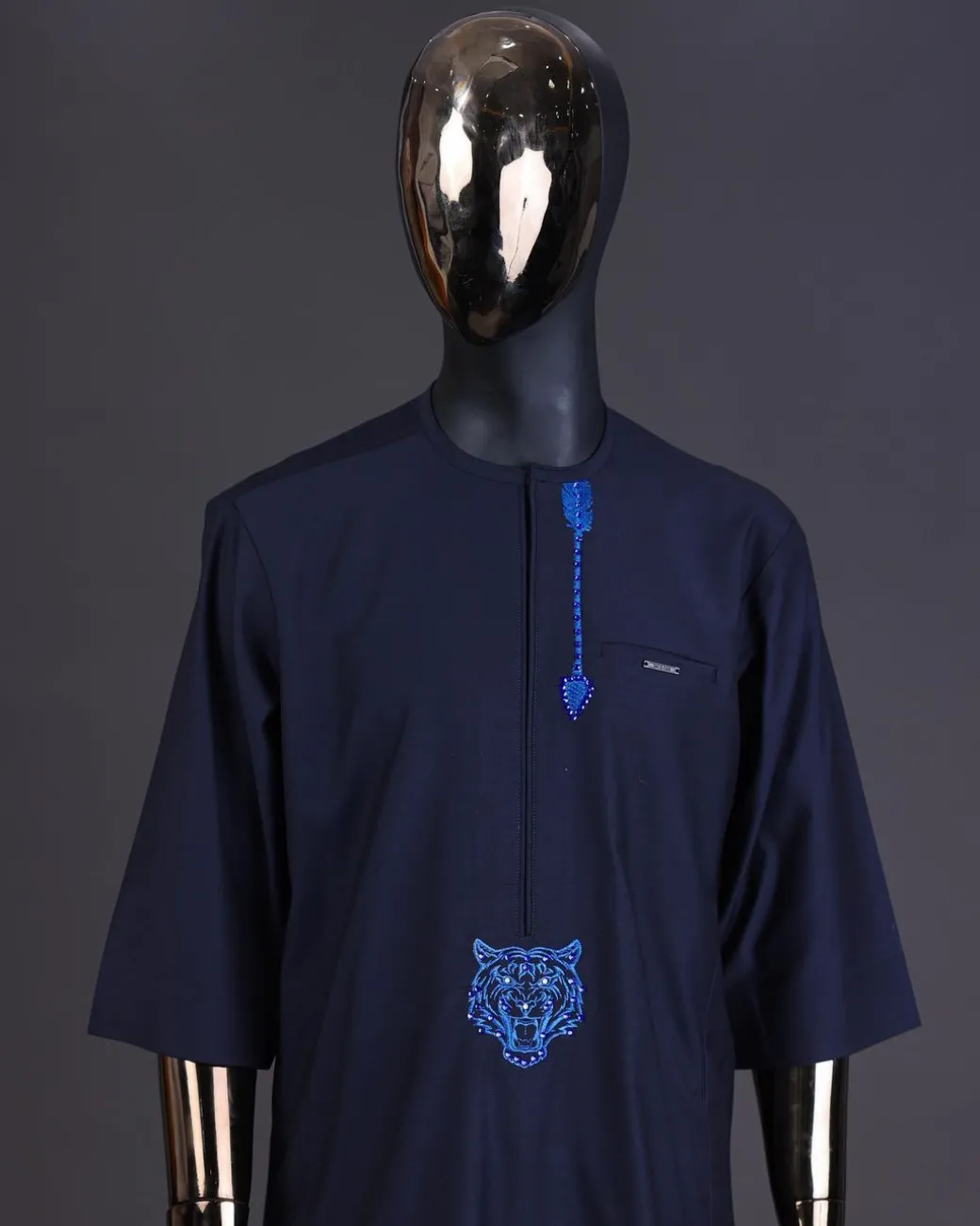 A Navy blue arrow and tiger head embroidery detail with matching Swarovski stone kaftan and Sokoto