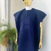 A navy blue aso oke dashiki with a floral and box-shaped embroidery design and hand-embroidered Yoruba hat
