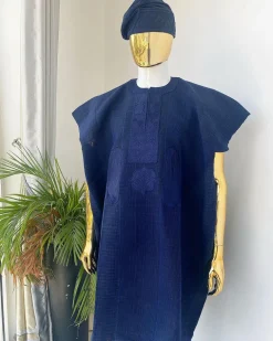 A navy blue aso oke dashiki with a floral and box-shaped embroidery design and hand-embroidered Yoruba hat