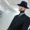 A Navy Blue Bowlers Hat with feathers detailings and Design
