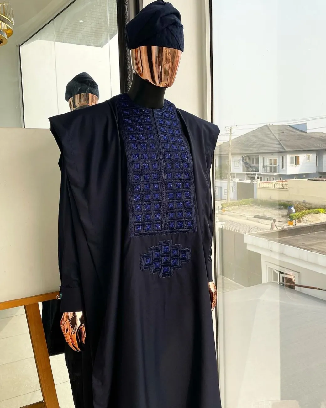 A Navy blue, connected square embroidery design with matching Skye blue Swarovski stone details agbada