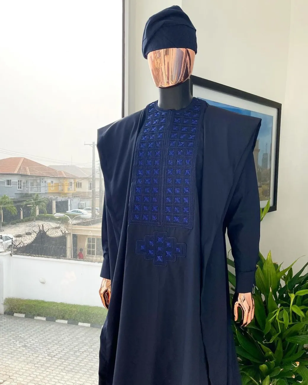 A Navy blue, connected square embroidery design with matching Skye blue Swarovski stone details agbada