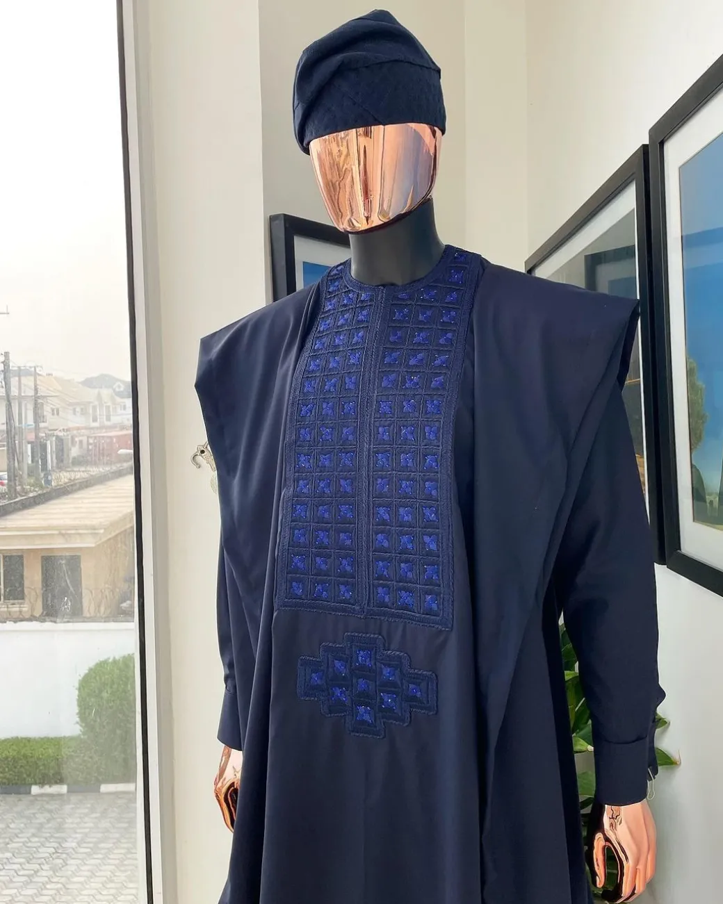 A Navy blue, connected square embroidery design with matching Skye blue Swarovski stone details agbada