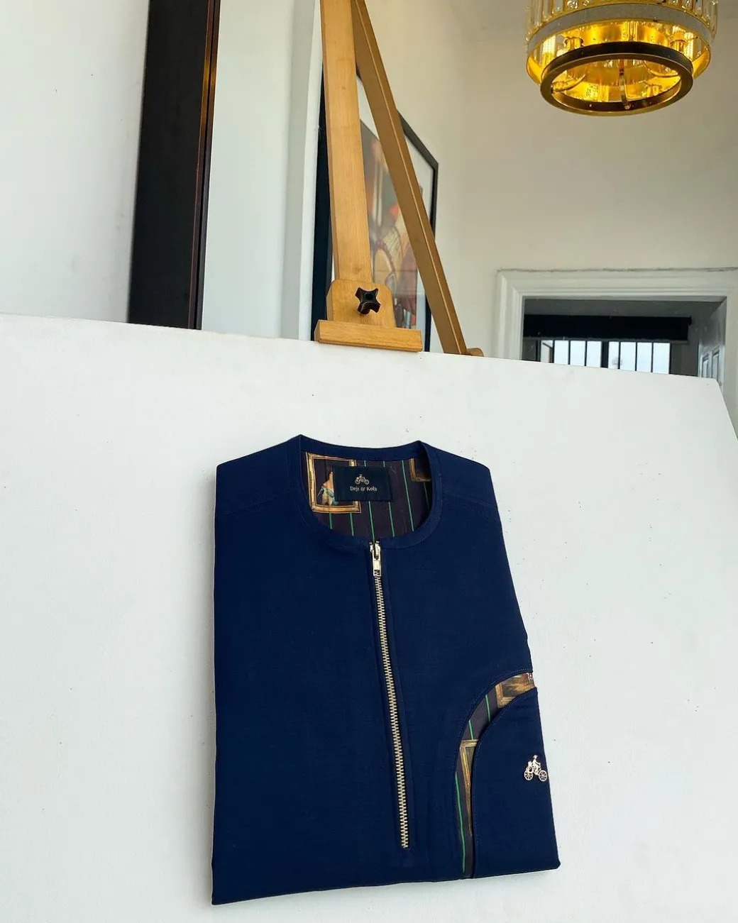 A Navy blue, curved rainbow pocket, gold zip line detailing African traditional senator kaftan