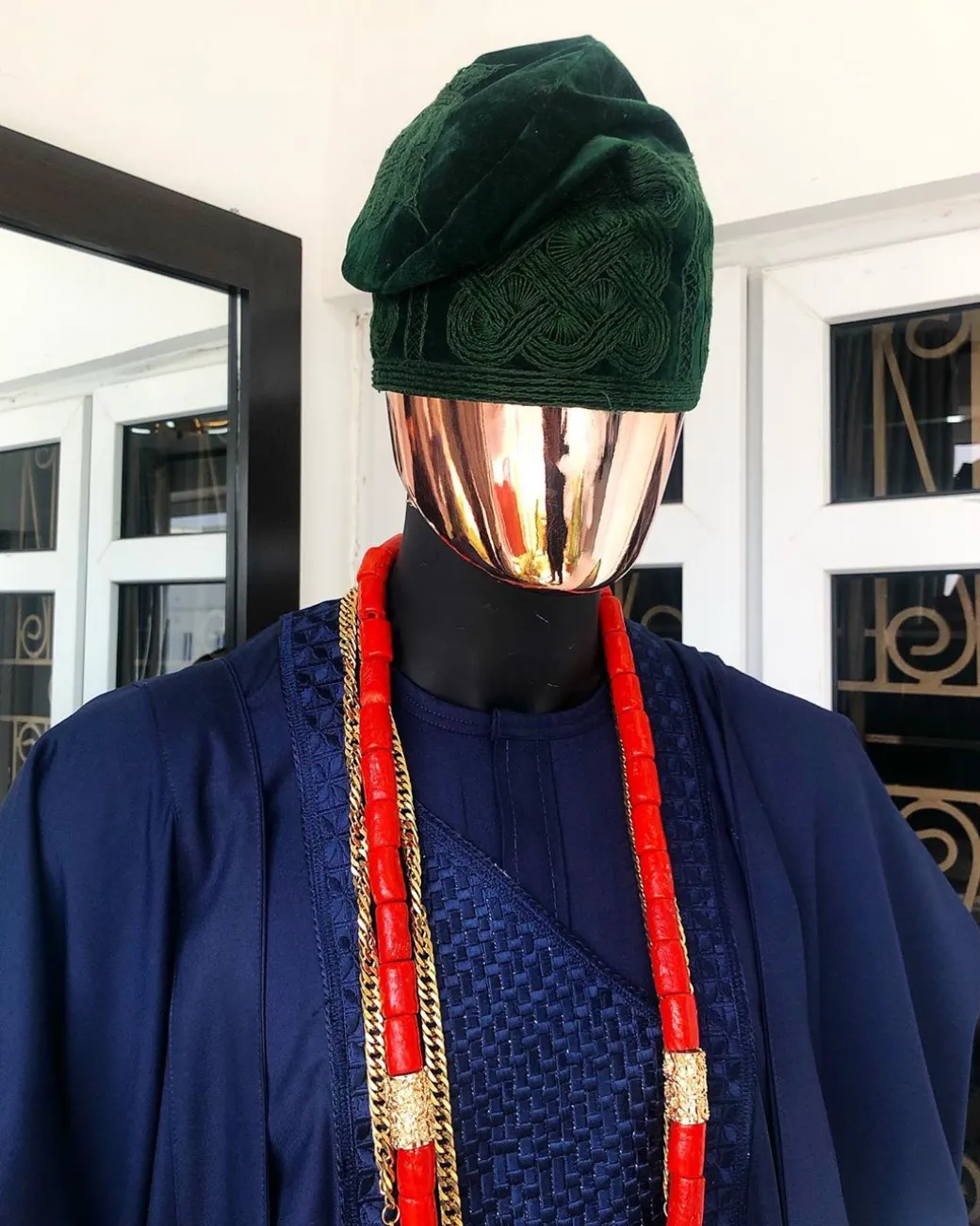 A Navy Blue embroidery details Agbada and Hand Woven Army Green Velvet Yoruba Hat and sokoto