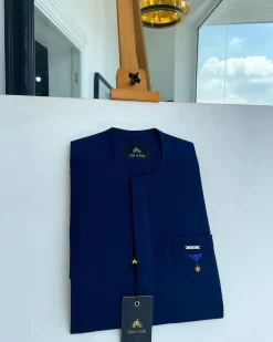A Navy blue, front flap and slant pocket with inverted tree detailing senator kaftan native.