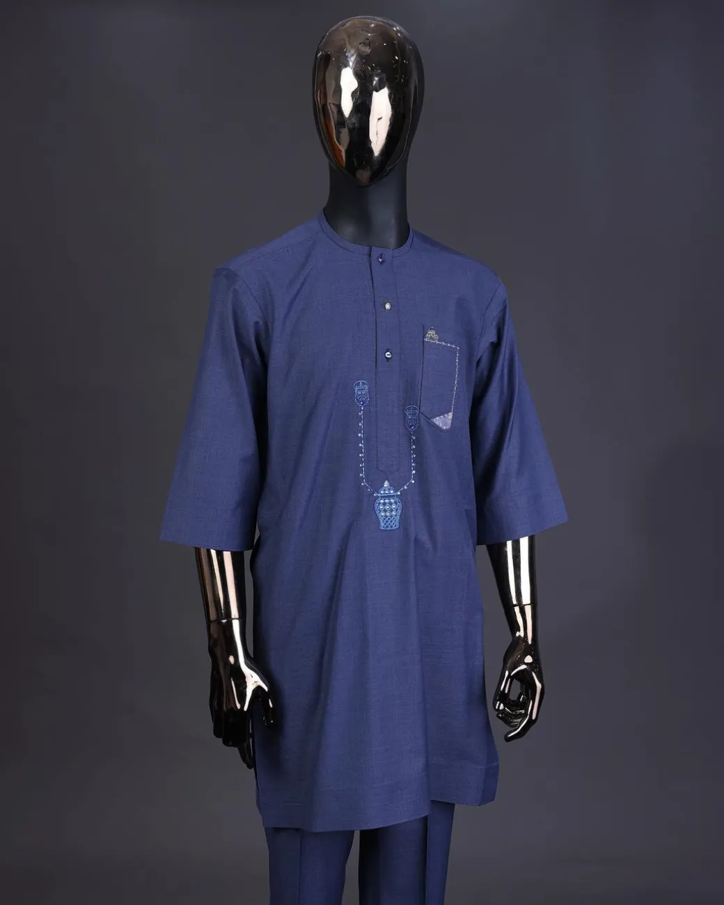 A Navy blue front flap with a clear view Swarovski button, connected sailor and basket embroidery detailing kaftan and Sokoto