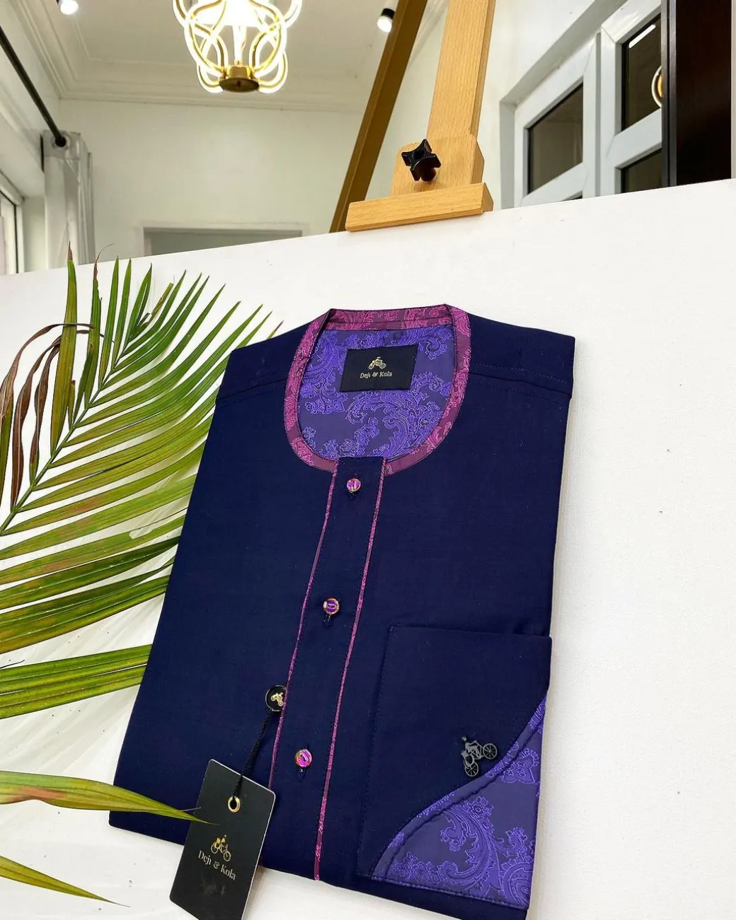 A Navy blue front flap with a clear view of Swarovski crystal buttons, short-sleeve African kaftan