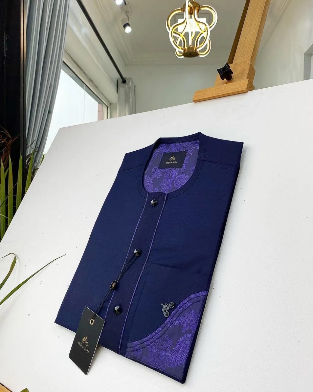 A Navy blue front flap with a clear view of the Swarovski and purple paisley African kaftan