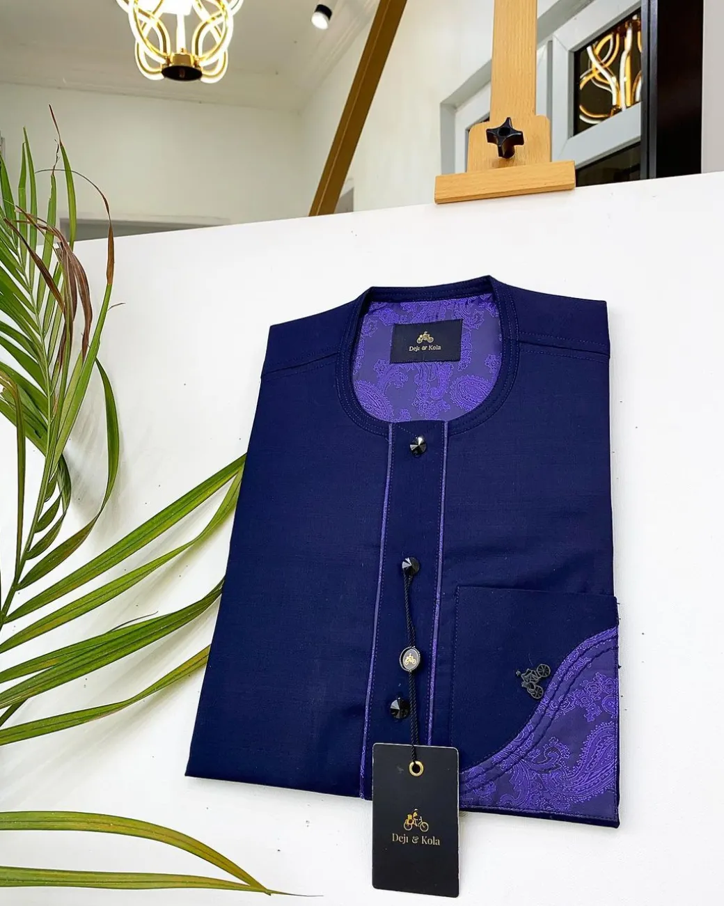 A Navy blue front flap with a clear view of Swarovski crystal buttons, short-sleeve African kaftan