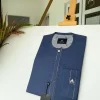 A navy blue kaftan with an interlocking patch pocket design.
