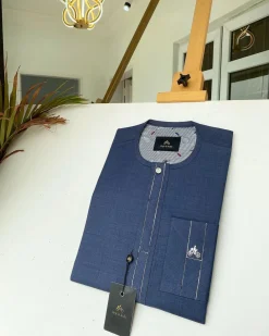 A navy blue kaftan with an interlocking patch pocket design.
