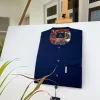 A Navy blue kaftan with purple paisley detailing, matching Swarovski button and sokoto