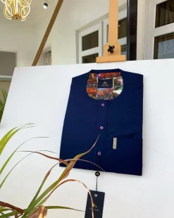 A Navy blue kaftan with purple paisley detailing, matching Swarovski button and sokoto