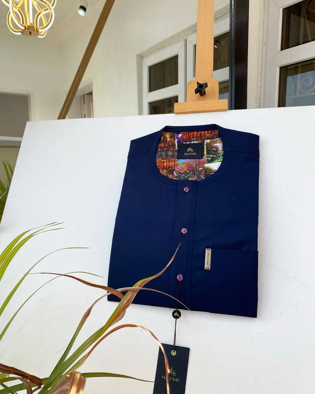 A Navy blue kaftan with purple paisley detailing, matching Swarovski button and sokoto
