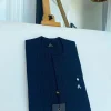 A Navy blue pencil stripe combat pocket with a clear view Swarovski silver button, front flap African kaftan native