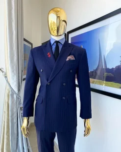 A Navy blue pinstripe double-breasted “Board Room” peak lapel suit