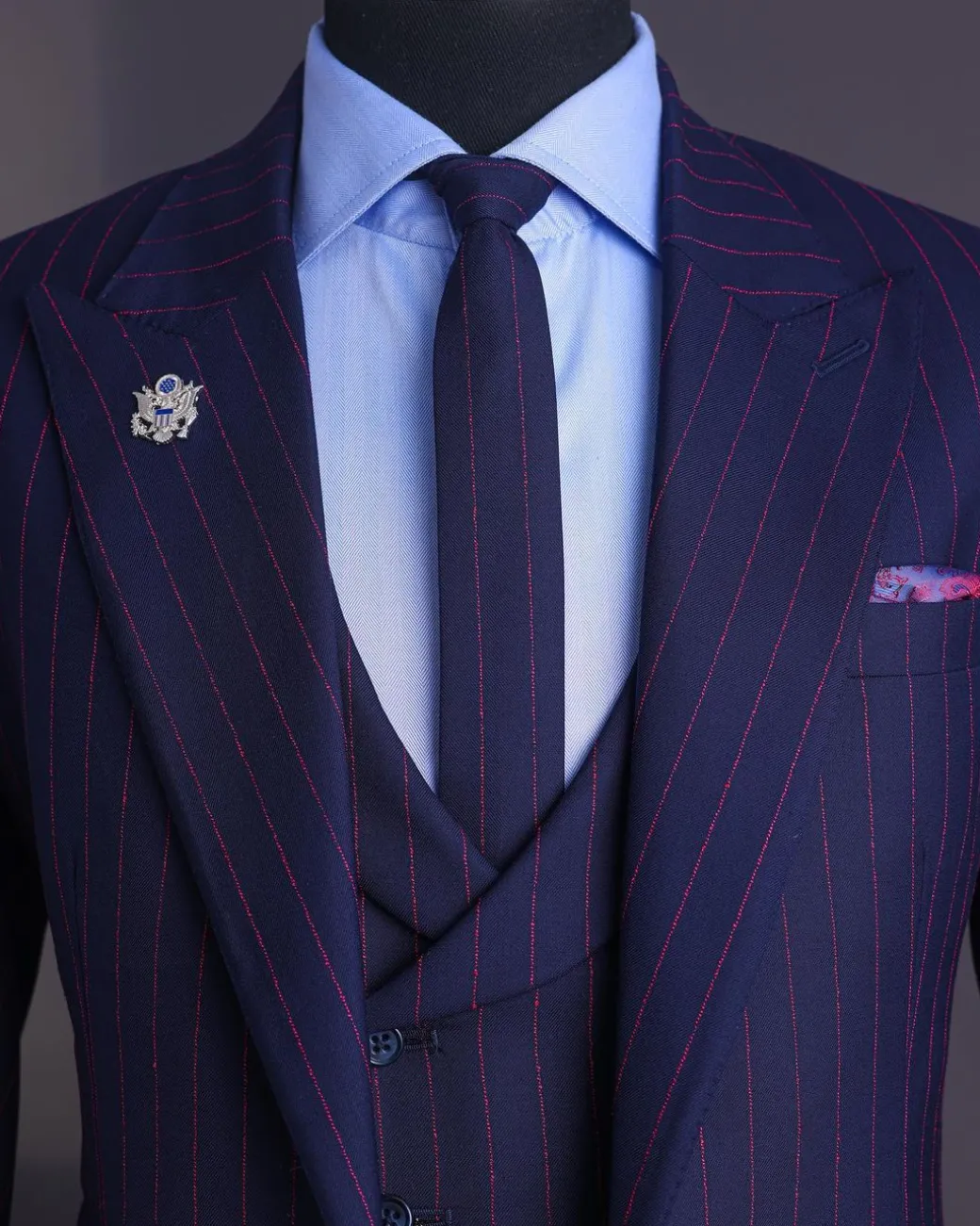 A Navy blue, red pencil stripe, jorgecarli, peak lapel suit.