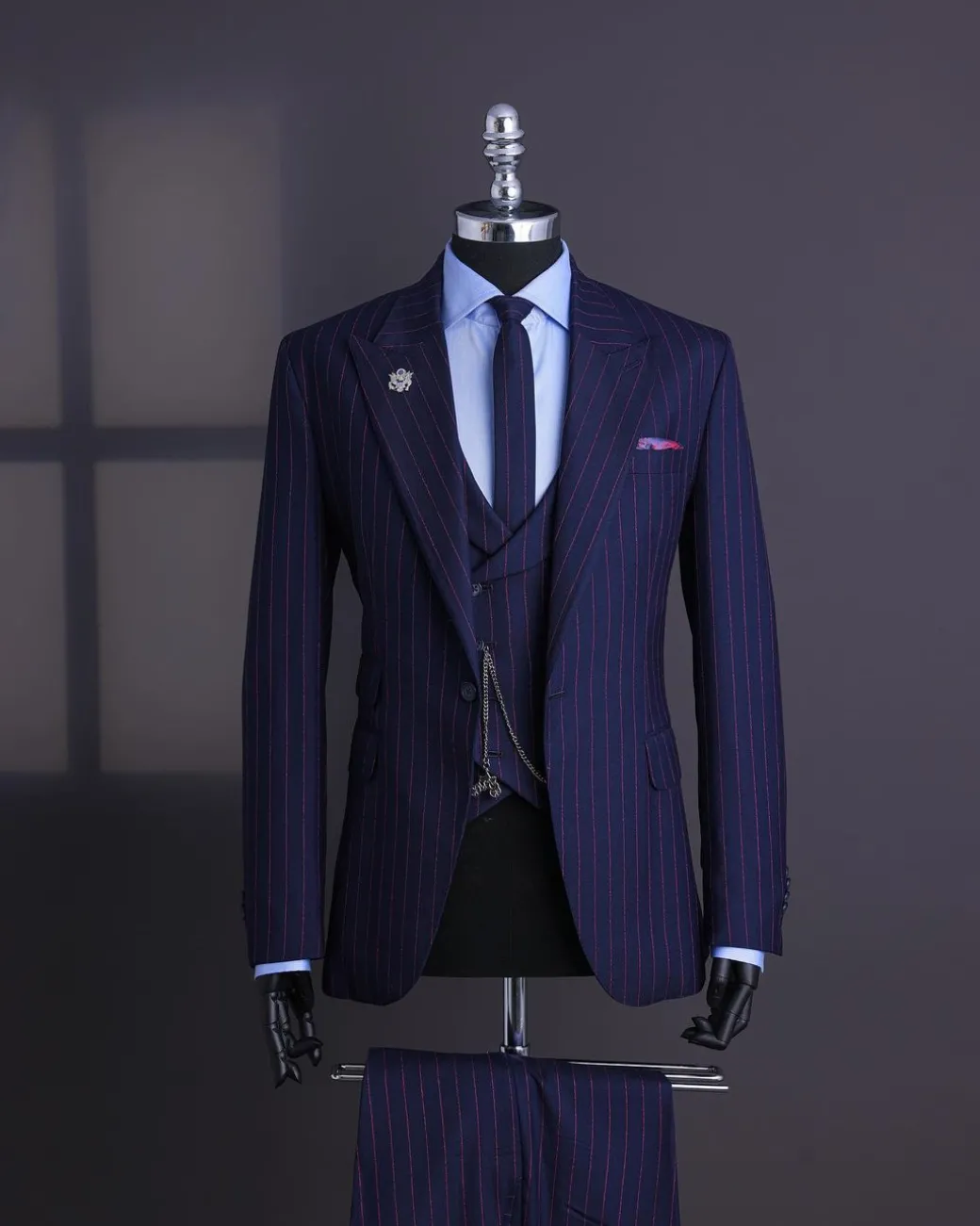 A Navy blue, red pencil stripe, jorgecarli, peak lapel suit.