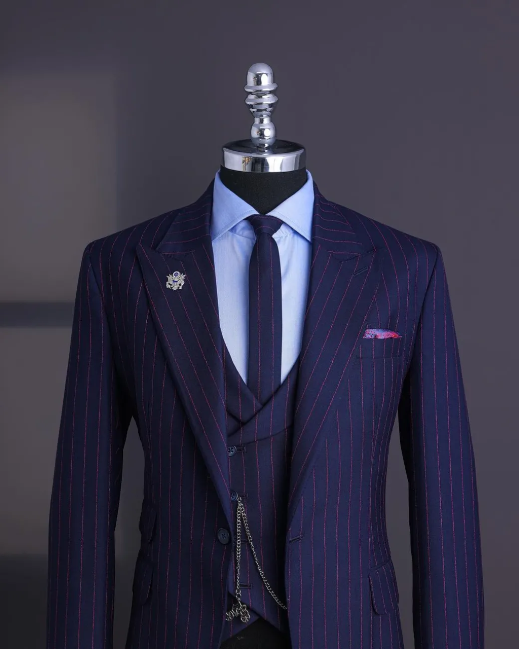 A Navy blue, red pencil stripe, jorgecarli, peak lapel suit.