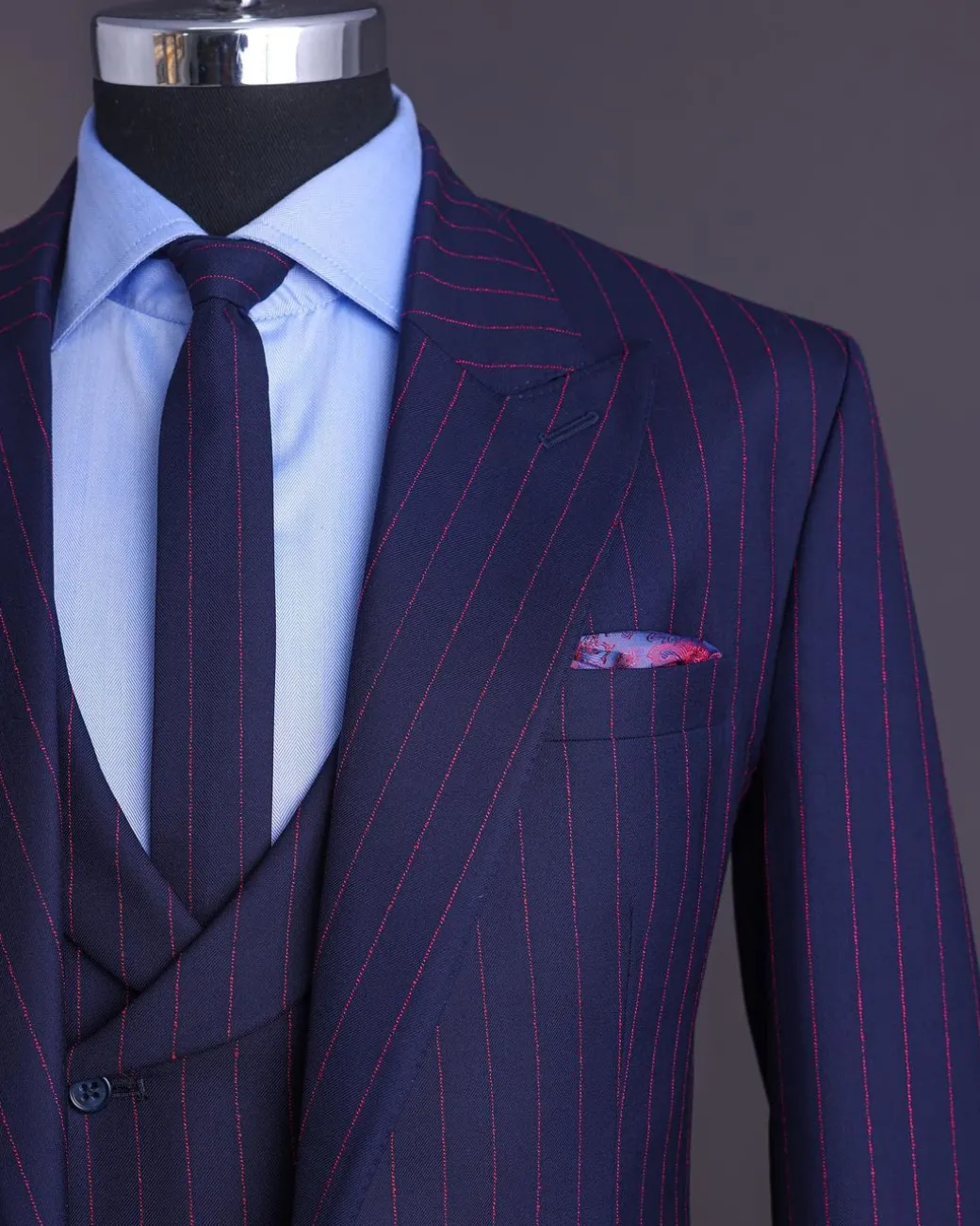 A Navy blue, red pencil stripe, jorgecarli, peak lapel suit.