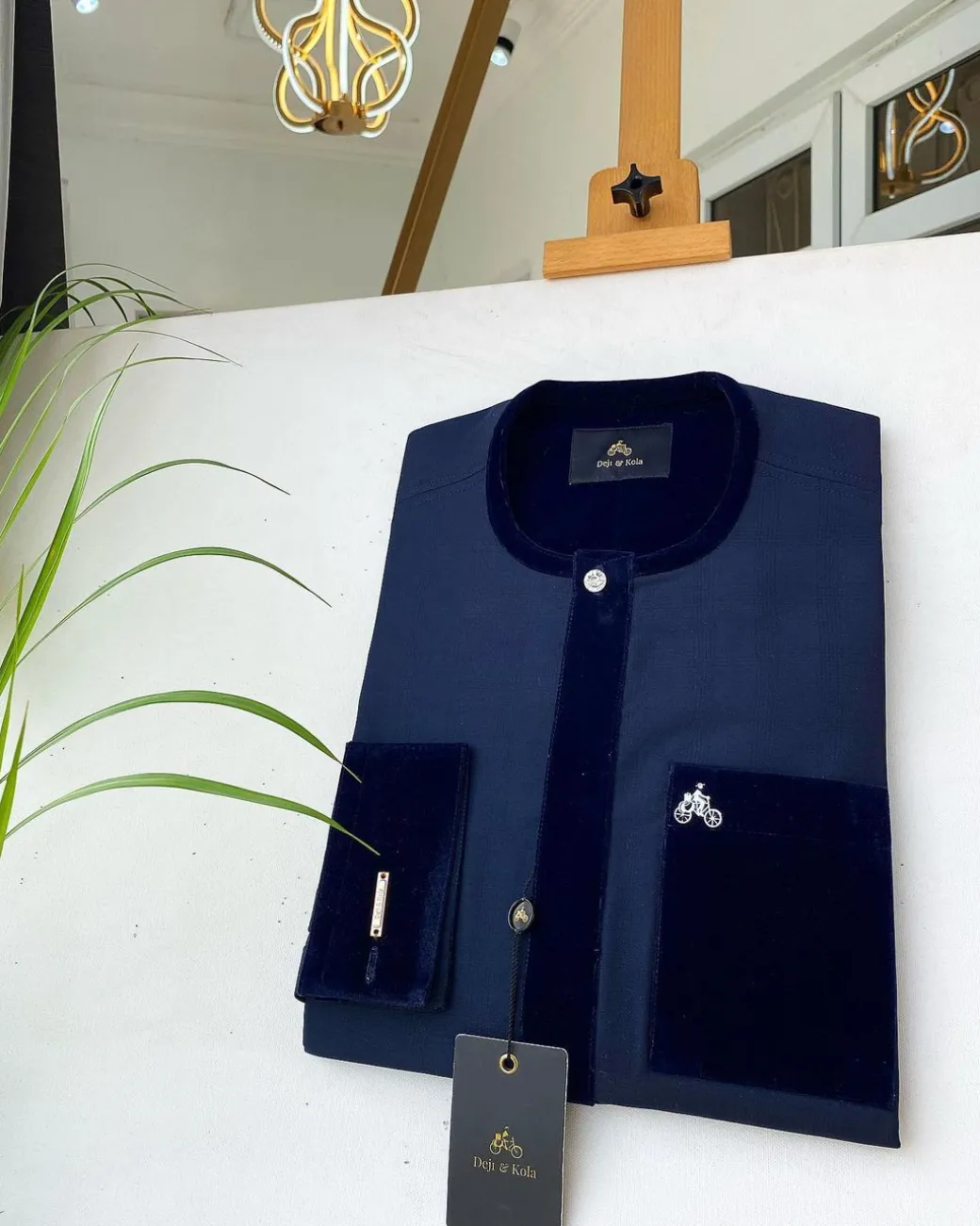 A Navy blue senator with a velvet flap pocket and cuff detail African Kaftan