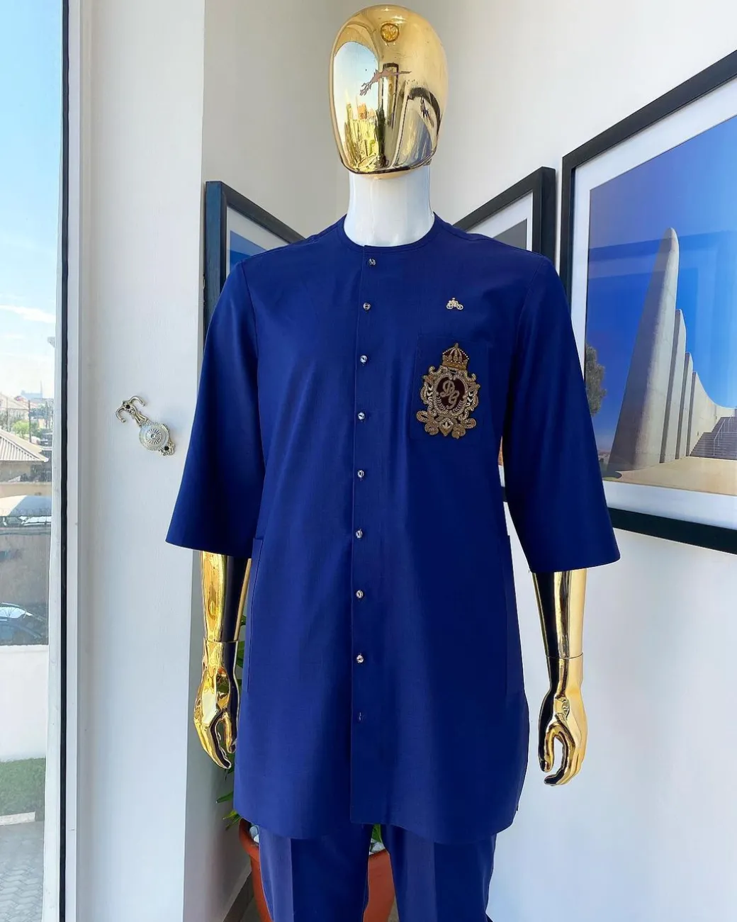 A navy blue “shirtan”, clear view jet black Swarovski button detailing, and hand-woven metal wire embroidery patch African traditional senator kaftan native