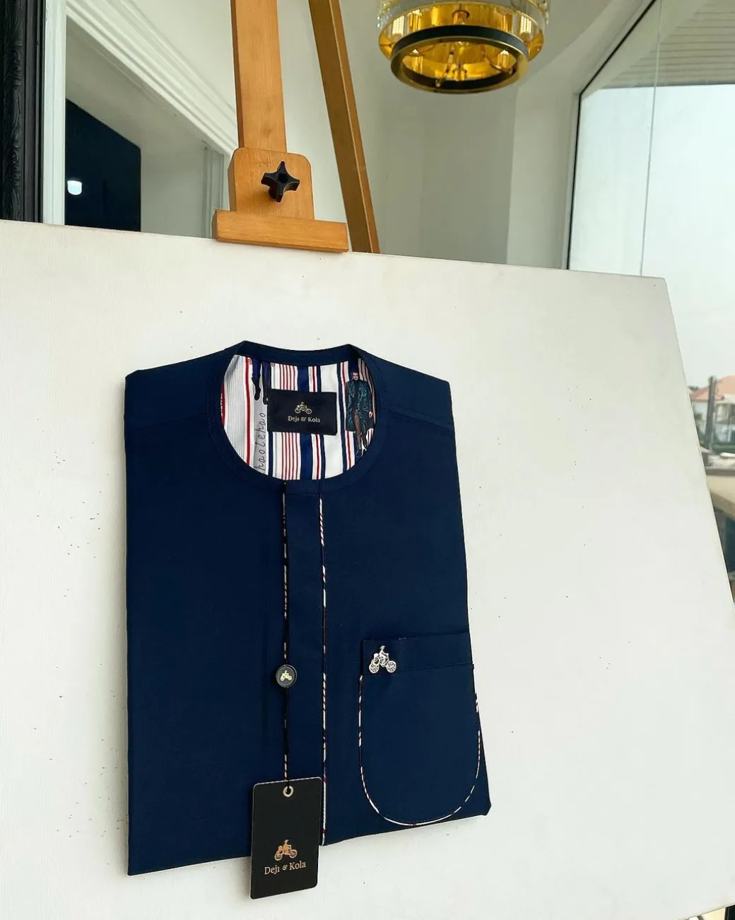 A Navy blue, sport paisley detailing flap and patch pocket and dotted front flap African traditional senator kaftan native.